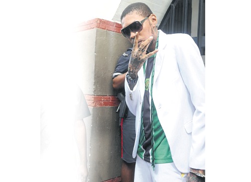 Vybz Kartel flashes the ‘Gaza’ sign as he exits the Supreme Court in downtown Kingston yesterday. The entertainer was given life imprisonment with the possibility of parole after 35 years for his role in the August 2011 murder of Clive ‘Lizard’ Williams. (PHOTO: BRYAN CUMMINGS)